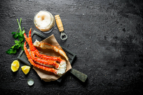 Crab with beer, parsley and lemon slices. On black rustic background - Fotografie, Obrázek