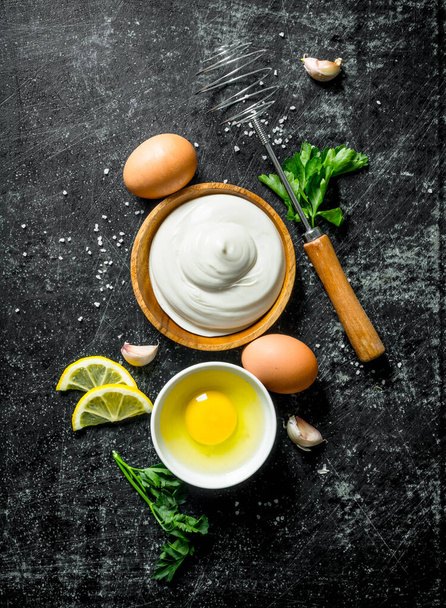 Mayonnaise with herbs, lemon and eggs. On dark rustic background - Fotoğraf, Görsel