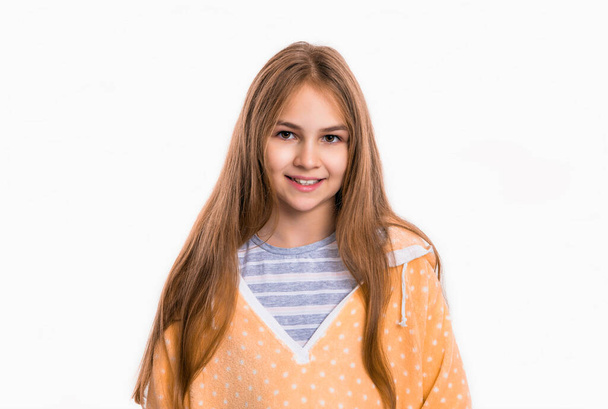 photo of smiling teen girl wearing homewear. cute teen girl in homewear. teen girl in homewear isolated on white background. teen girl wear homewear in studio. - Photo, image
