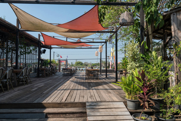 Outdoor cafe and restaurant by Chao Phraya river at Koh kret, Nonthaburi, Thailand.. - Photo, Image