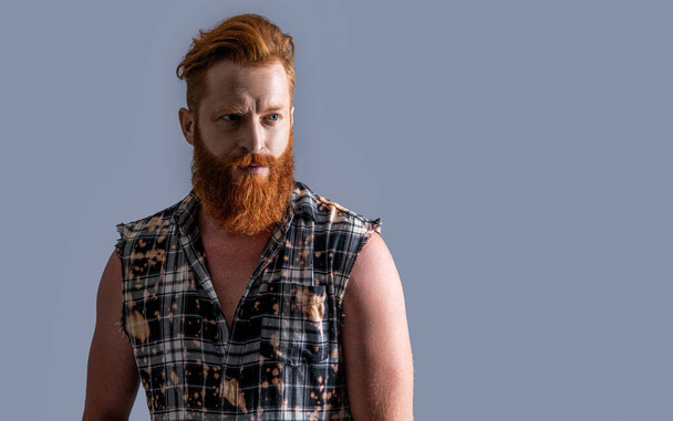 brutal bearded guy isolated on grey, copy space. brutal bearded guy in studio. brutal bearded guy on background. photo of brutal bearded guy with beard. - Foto, imagen