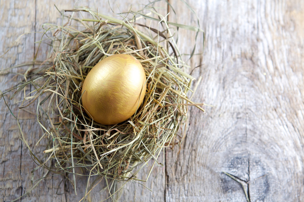 Easter decorations. Eggs in nests on wooden background - Foto, afbeelding