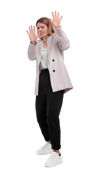 Beautiful businesswoman avoiding something on white background - Photo, image