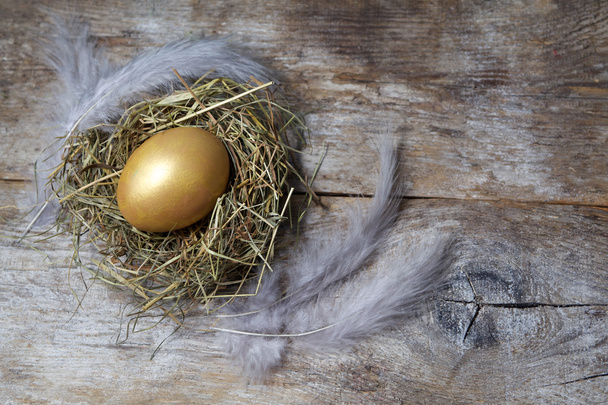Easter decorations. Eggs in nests on wooden background - Photo, Image