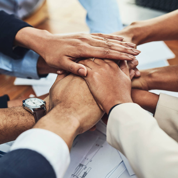 Closeup of hands together, business people in meeting and solidarity, support and team huddle with collaboration. Group of employees working, teamwork and mission with hand stack over paperwork. - Fotó, kép