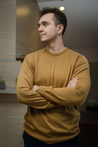 Portrait of young adult caucasian man standing at home wear sweater - Fotó, kép