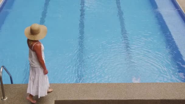 Woman walking by the pool - Footage, Video