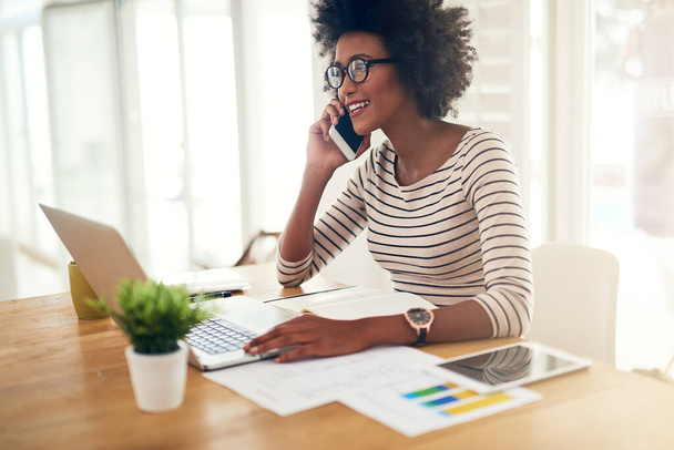 Phone call, laptop and black woman accountant talking financial company or startup strategy in home office. Cellphone, happy and entrepreneur or employee planning graph results doing remote work. - Foto, Imagem