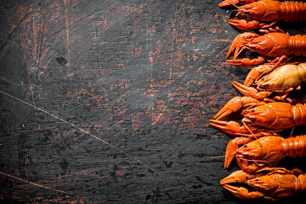 Fragrant boiled crayfish. On dark rustic background - Fotografie, Obrázek