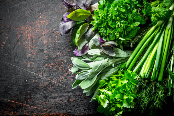 Useful herbs on the wooden tray. On dark rustic background - 写真・画像