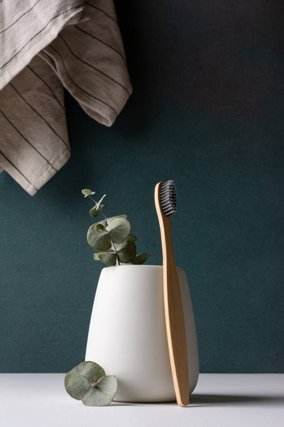 Eco-friendly bamboo toothbrushes in a white holder. Zero waste, plastic free, sustainable lifestyle concept. - Foto, Imagen