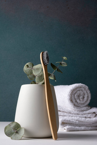 Eco-friendly bamboo toothbrushes in a white holder. Zero waste, plastic free, sustainable lifestyle concept. - Valokuva, kuva