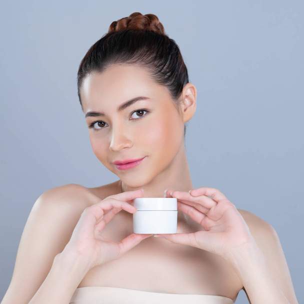 Glamorous beautiful perfect cosmetic skin with soft makeup woman portrait hold mockup jar cream or moisturizer for skincare treatment and anti-aging product advertisement in isolated background. - 写真・画像