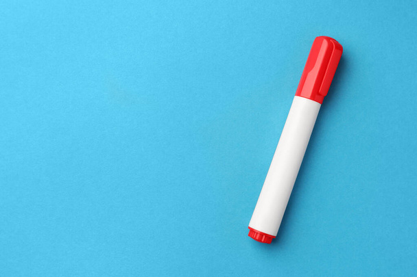 Bright red marker on light blue background, top view. Space for text - Fotó, kép