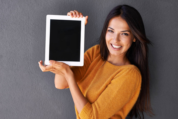 Confidence looks like this. Portrait of an attractive young woman holding up a digital tablet with a blank screen - Foto, afbeelding