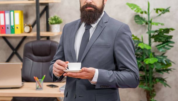 cropped mature entrepreneur in jacket having coffee break at office, lunch break. - Foto, imagen