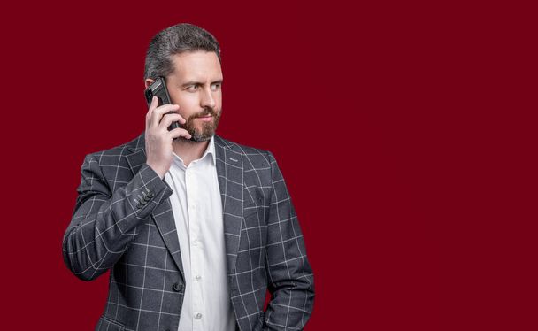 businessman speak on phone. photo of businessman speak on phone. formal businessman speak on phone isolated on red background. businessman in formal menswear speak on phone in studio. - Foto, immagini