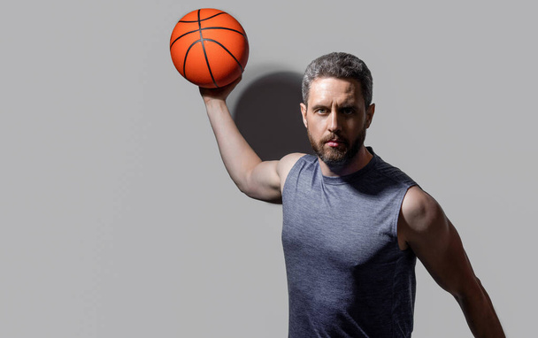 sportsman play dunk basketball isolated on grey background. sportsman play dunk basketball in studio. professional sportsman play basketball with dunk ball. sportsman play dunk basketball - Φωτογραφία, εικόνα
