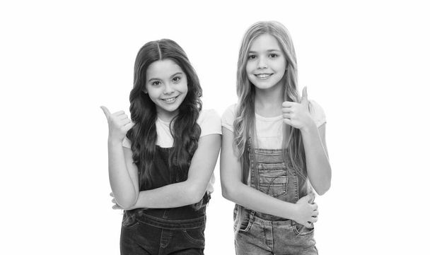 Thumbs up for fashion show. Cute little fashion models gesturing isolated on white. Adorable girls with fashion look. Small children wearing long hair in fashion way. - Fotoğraf, Görsel