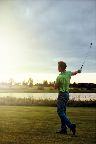 More than a game, its a full body experience. a young man spending the day on a golf course - 写真・画像