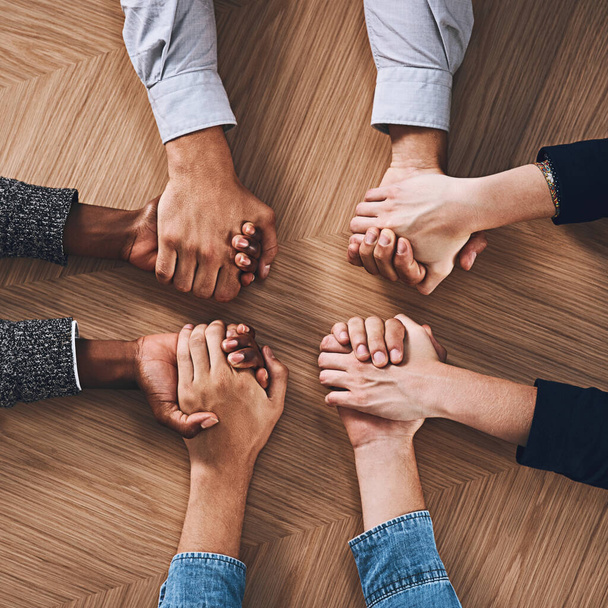 Above, partnership or business people holding hands for support, teamwork or strategy in office. Motivation, zoom or employees in group collaboration with diversity or mission for goals together. - Фото, изображение