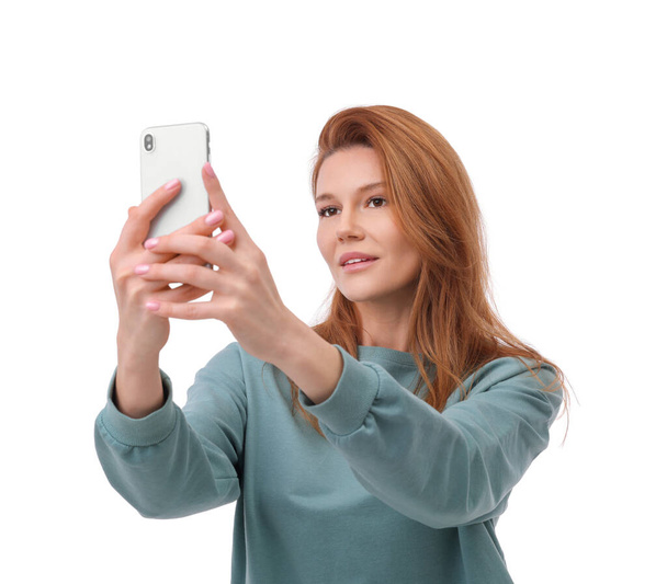 Beautiful woman taking selfie on white background - Fotografie, Obrázek