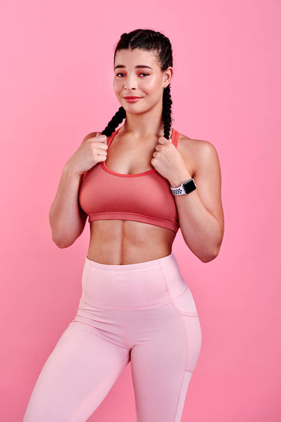 Ive overcome so many things that I thought were impossible. Studio portrait of a sporty young woman posing against a pink background - Zdjęcie, obraz