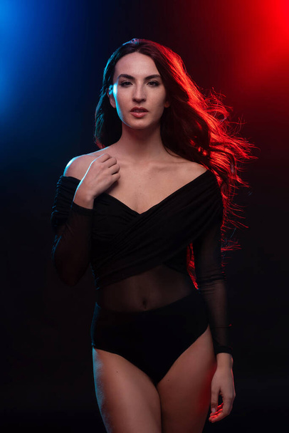 Sensual brunette woman portrait wearing black body. Colorful gel photography. - Zdjęcie, obraz