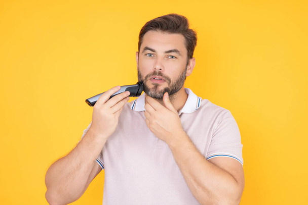 Man with scissors. Man cut hair with hairdressing scissors. Men haircut in studio. Barber scissors. Mens cut beard hair. Guy holding scissors - Fotografie, Obrázek