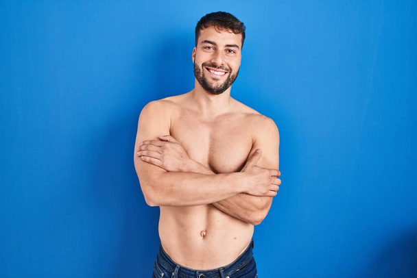 Handsome hispanic man standing shirtless happy face smiling with crossed arms looking at the camera. positive person.  - Фото, изображение