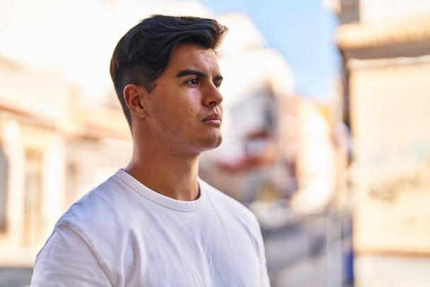 Young hispanic man looking to the side with serious expression at street - Fotoğraf, Görsel