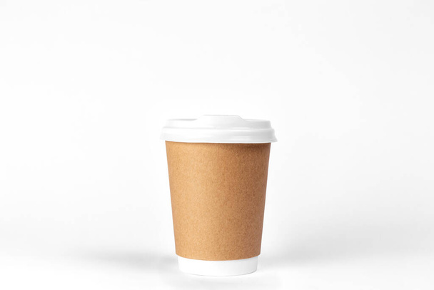 Disposable paper cup for takeaway drinks on a white background isolated. - Photo, image