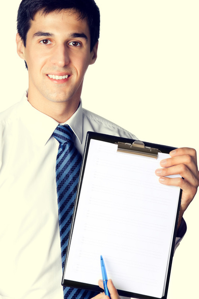 Businessman showing clipboard - Фото, изображение