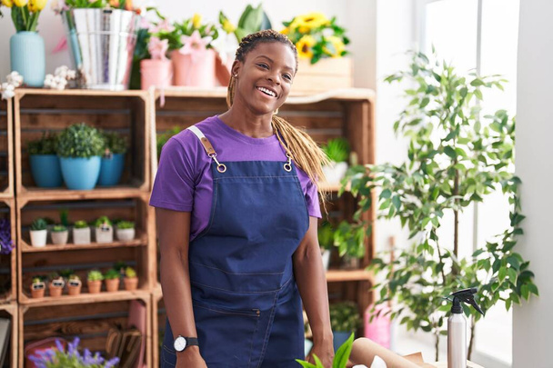 African american woman florist smiling confident standing at florist - Photo, Image