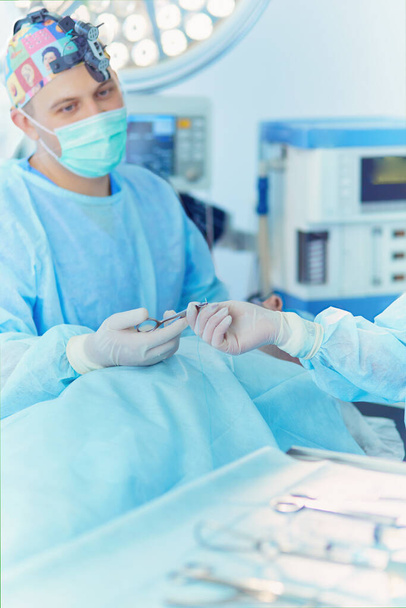 Male surgeon on background in operation room. - Zdjęcie, obraz