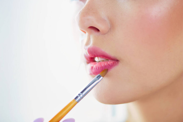 Beautiful girl with cosmetic powder brush for make up. Makeup. Make-up applying for perfect skin. - Фото, зображення