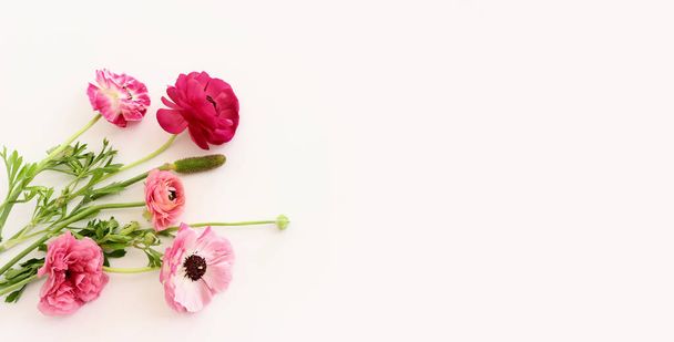 Top view image of pink flowers composition over white isolated background - Фото, изображение