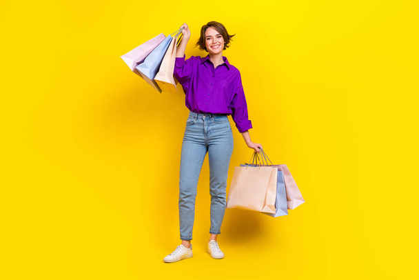 Full length photo of dreamy excited lady wear violet shirt rising bargains isolated yellow color background. - Fotoğraf, Görsel