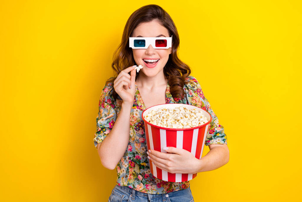 Photo of funky overjoyed person arm hold big pop corn bucket watch 3d glasses movie isolated on yellow color background. - Foto, Imagen