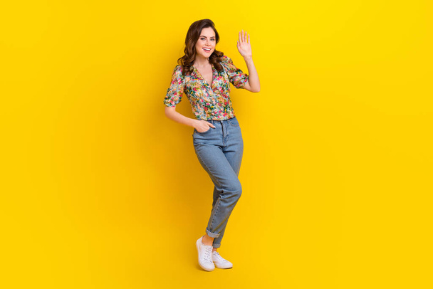 Full size photo of adorable sweet lady standing posing waving hand saying hello to her friends isolated vibrant color background. - Zdjęcie, obraz