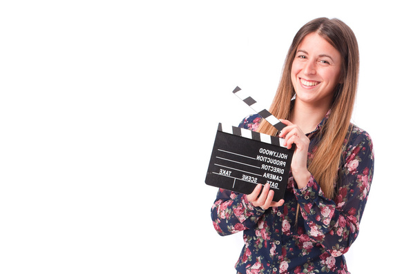 Happy girl holding a clapperboard - Foto, afbeelding