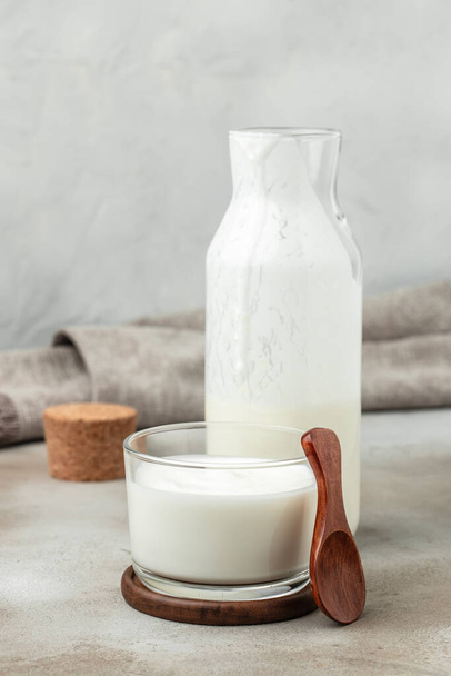homemade yogurt, kefir, fermented milk on a light background. Healthy, clean eating. Vegan or gluten free diet. - Фото, изображение