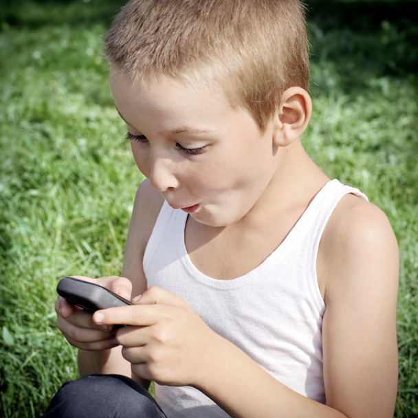 Kid with Cellphone outdoor - Photo, Image