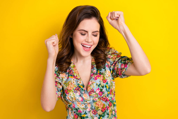 Portrait of delighted cheerful person closed eyes raise fists triumph isolated on yellow color background. - Foto, imagen