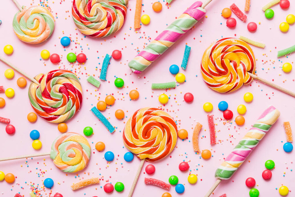 Tasty appetizing Party Accessories Happy Birthday Sweet. Different types of candies on colored background, copy space. Colorful birthday party background. - Φωτογραφία, εικόνα