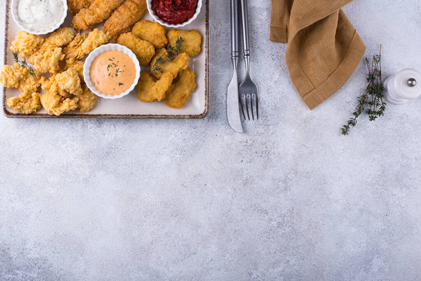 Different boneless chicken fried nuggets, strips and bites - 写真・画像