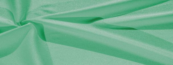 зелений шовк. Гладка елегантна зелена розкішна шовкова тканина може бути використана як абстрактний фон з простором для копіювання, крупним планом. барвиста текстура
 - Фото, зображення