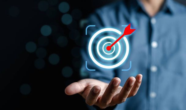 Businessman holding business target objective virtual icon, planning development leadership and customer target group, investment growth and success development, achievement, goal, strategy, finance. - Foto, Imagen