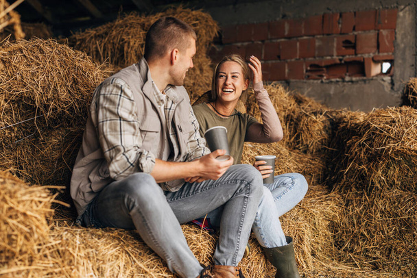 A young couple handing out in a haystack. - Foto, Imagen