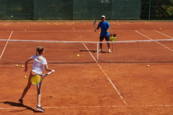 A professional tennis player and her coach training on a sunny day at the tennis court. Training and preparation of a professional tennis player. - Foto, Bild